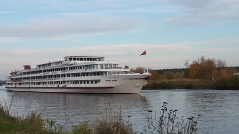 A big ship is sailing on a small river. Meeting of the ship and boat Stock Footage 140621259
