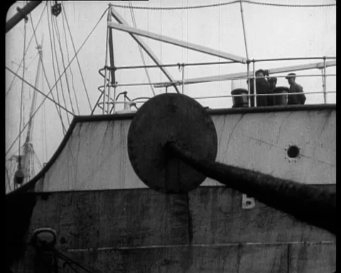 Big ship staying in a dock while little mice run on the wire, Rat Menace, 1925 Video stock 131081409