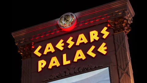 Big sign 'Caesars Palace' in front of casino at night. Las Vegas, Nevada, USA. Stock Footage 283638583