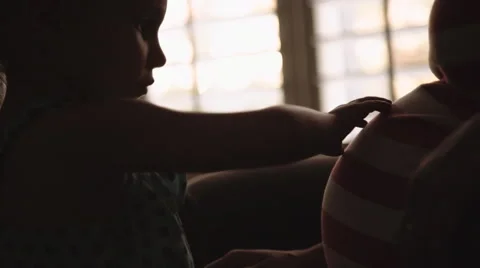 Big Sister Anticipates Arrival of Her Younger Sibling By Rubbing Her Mom's Belly Stock Footage 59134762