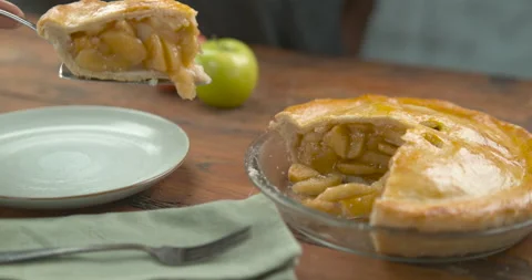 Big slice of apple pie placed in a pastel blue plate with a palette knife, on a Stock Footage 199460915