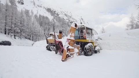 A big snow blower parked in the snow Stock Footage 103209728