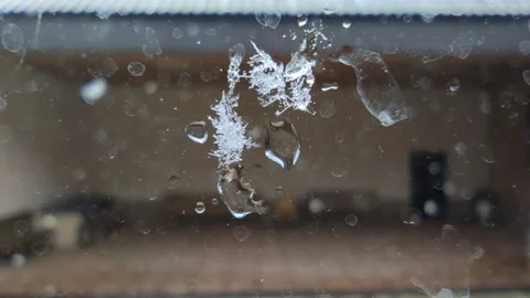 A big snowflake melting on the window Video stock 226363457