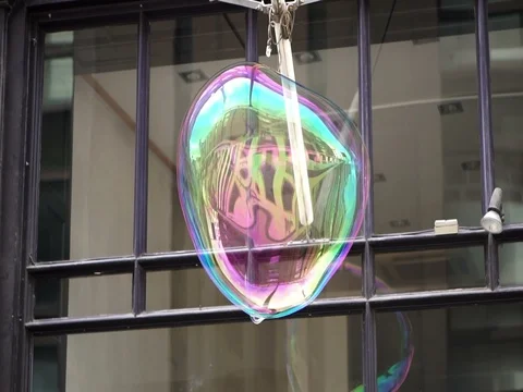 Big soap bubble being made and floating in the air then explode in slow motion Stock Footage 75888213