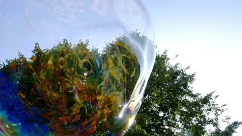 Big soap bubble being made and floating in the air then explode in slow motion Stock Footage 144419601
