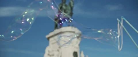 Big soap bubbles in the air in Lisbon Stock Footage 151354469