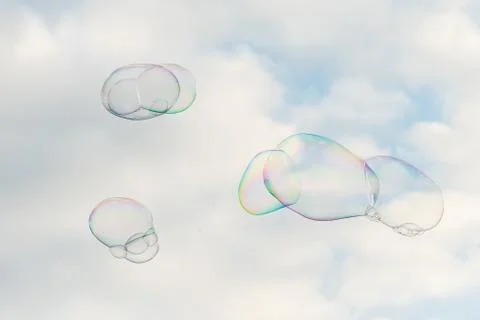 Big soap bubbles in front of partly cloudy sky Stock Photos