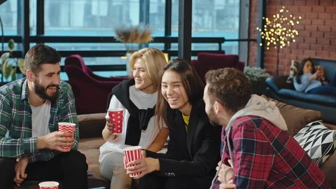 On a big sofa in a modern college library multiethnic mature students Stock Footage 122751982