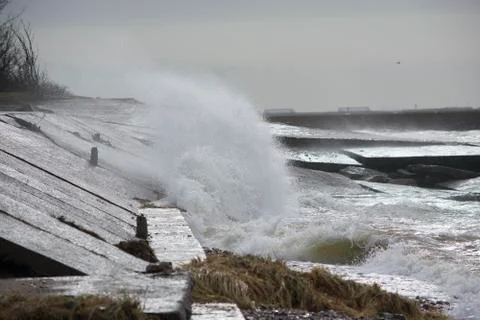 Big splash of water. Waves hitting concrete sea wall pier Stock Photos