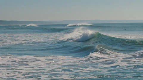 Big splashing ocean waves rushes towards the coast on a sunny day Stock Footage 130626581