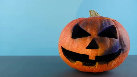 Big spooky pumpkin, isolated on blue studio background with copy space Stock Footage 139921475