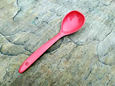 A big spoon on stone background Stock Photos