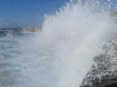 Big Spray from Huge Wave on Rocks Stock Photos