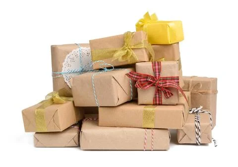Big stack of gifts wrapped in brown kraft paper and tied with silk ribbon ... Stock Photos