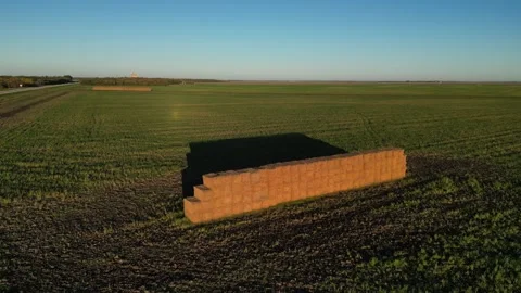 Big stack of hay stacked in the field at harvest corp season Stock-Footage 319427107