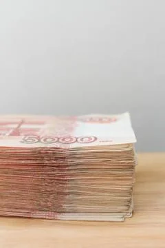 Big stack of Russian money banknotes of five thousand rubles lying on a woode Stock Photos