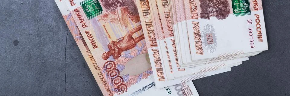 Big stack of Russian money banknotes of five thousand rubles lying on a grey  Stock Photos