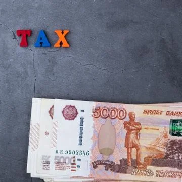 Big stack of Russian money banknotes of five thousand rubles lying on a grey  Stock Photos