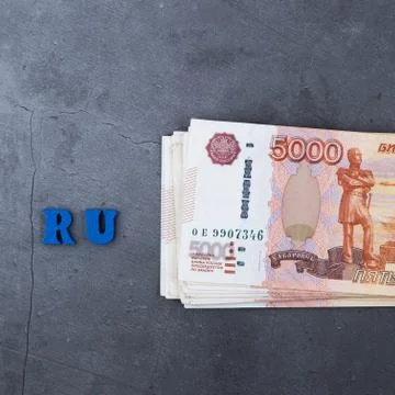 Big stack of Russian money banknotes of five thousand rubles lying on a grey  Stock Photos