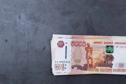 Big stack of Russian money banknotes of five thousand rubles lying on a grey  Stock Photos