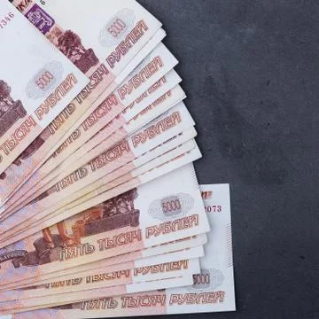 Big stack of Russian money banknotes of five thousand rubles lying on a grey  Stock Photos