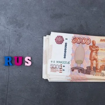 Big stack of Russian money banknotes of five thousand rubles lying on a grey  Stock Photos