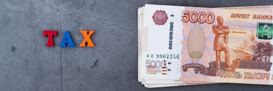 Big stack of Russian money banknotes of five thousand rubles lying on a grey  Stock Photos