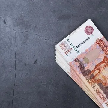 Big stack of Russian money banknotes of five thousand rubles lying on a grey  Stock Photos