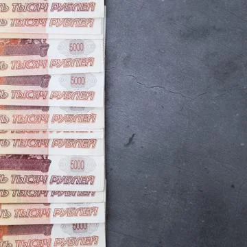 Big stack of Russian money banknotes of five thousand rubles lying on a grey  Stock Photos