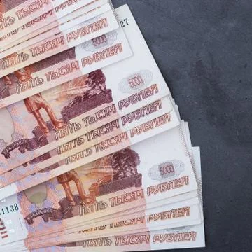 Big stack of Russian money banknotes of five thousand rubles lying on a grey  Stock Photos