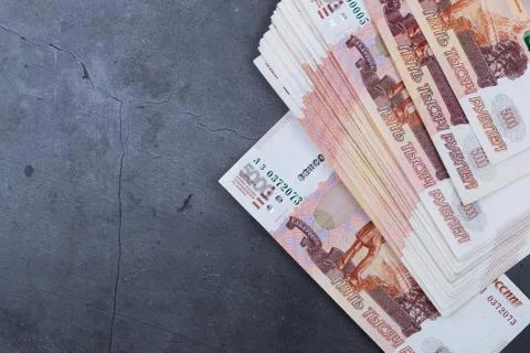 Big stack of Russian money banknotes of five thousand rubles lying on a grey  Stock Photos