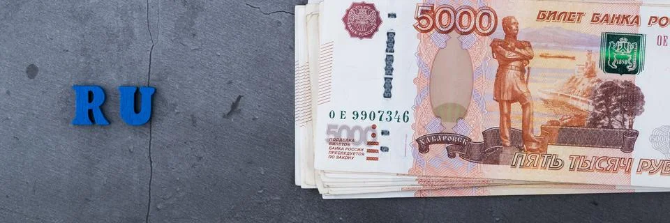Big stack of Russian money banknotes of five thousand rubles lying on a grey  Stock Photos