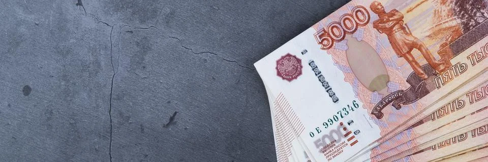 Big stack of Russian money banknotes of five thousand rubles lying on a grey  Stock Photos