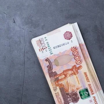 Big stack of Russian money banknotes of five thousand rubles lying on a grey  Stock Photos