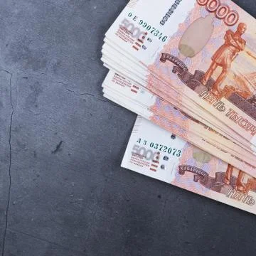 Big stack of Russian money banknotes of five thousand rubles lying on a grey  Stock Photos