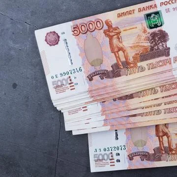 Big stack of Russian money banknotes of five thousand rubles lying on a grey  Stock Photos