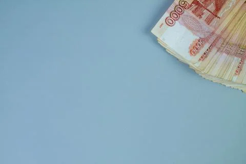 Big stack of Russian money banknotes of five thousand rubles lying on a grey Stock Photos