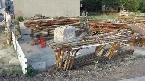 Big stack used rusted steel scaffold or scaffolding on empty construction space Stock Footage 113199919