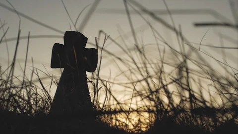 Big stone cross in the grass at sunset Stock Footage 103218047