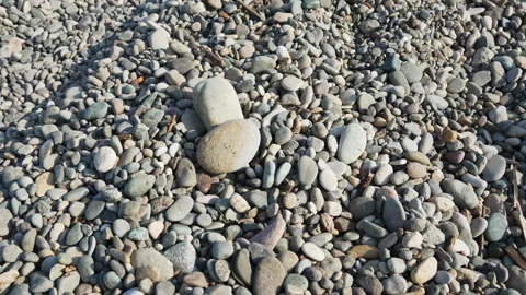 Big stone falls onto pebbles on the beach. Boulders fall as construction gravel Stock Footage 336586855