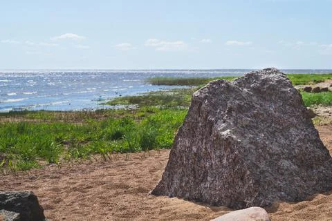 Big stone in the triangular prism shape on the sea shore. boulder on the coas 스톡 사진