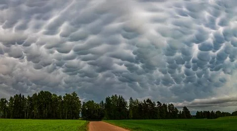 Big storm cloud over the fields mammatus clouds Stock Photos