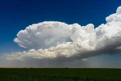 Big storm clouds develop, bursting into the atmosphere with dramatic texture  Stock Photos