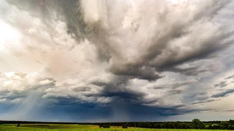 Big storm clouds over the field Stock Photos