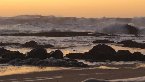 Big stormy rough waves on sea at dusk. Dark rocks in foreground. Dolly right. Stock Footage 116667543