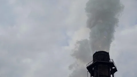A big stovepipe smokes on the mining and processing plant Stock Footage 95146124