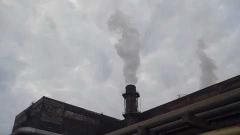 A big stovepipe smokes on the mining and processing plant Stock Footage 95146604