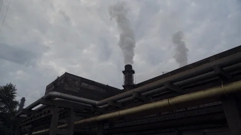A big stovepipe smokes on the mining and processing plant Stock Footage 95147111