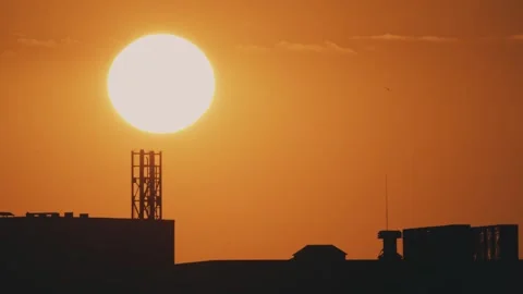 Big sun and a view of the rooftops of the city Stock Footage 316536815