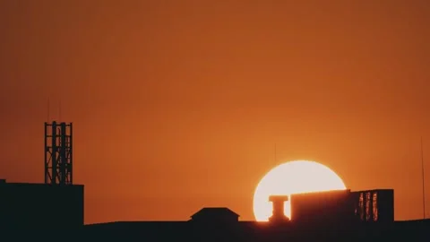 Big sun and a view of the rooftops of the city Stock Footage 316536977